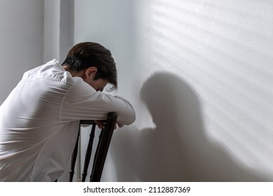Male depression. Upset Asian young man got problem sitting alone at home, a lot of thoughts, break up with a lover or financial difficulties and debt Overthinking Unhappy unsatisfied and trouble idea.