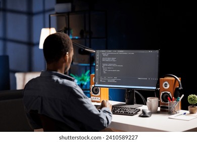Male developer entering binary data on terminal panel while establishing html code. Software engineer works on troubleshooting with programming language, for protection of databases.