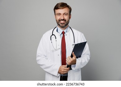 Male doctor confident man wears white medical gown suit work in hospital hold clipboard with paper account documents isolated on plain grey color background studio portrait Healthcare medicine concept - Shutterstock ID 2236736743