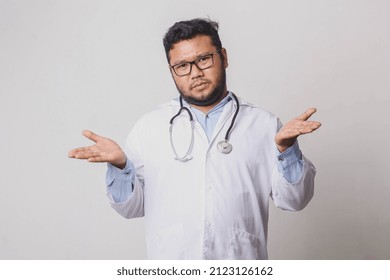 Male Doctor With Confused And Indifferent Expression Isolated On White Background