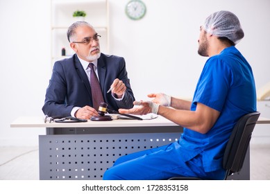 Male Doctor In Courthouse Meeting With Advocate