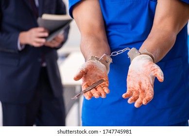 Male Doctor In Courthouse Meeting With Advocate