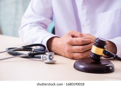 Male Doctor In Courthouse Meeting With Lawyer