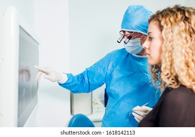 Male Doctor Dentist On The Computer Looking At A X-ray