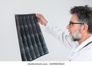 Male doctor diagnose spine lumbar spine MRI for diagnose Herniated disc disease with radiologic technologist team. Doctor examining X-ray images on display in MRI
 - Powered by Shutterstock