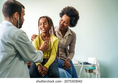 Male Doctor Examining A Child Patient In A Hospital