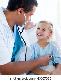 Male Doctor Examining A Child Patient In A Hospital