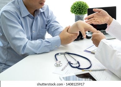 Male Doctor Are Examining The Patient's Wrist Pain.