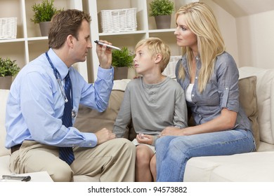 A Male Doctor Examining A Sick Boy Child With His Mother During A Home Visit