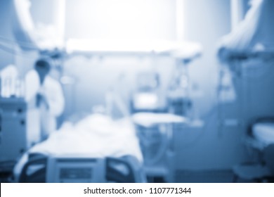 Male Doctor Figure Next To The Patient Bed In The Intensive Care Unit, Unfocused Background.