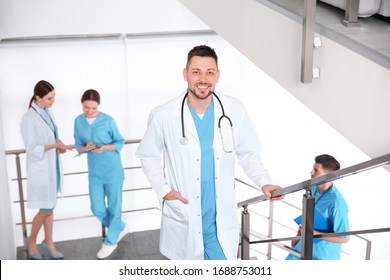 Male doctor going upstairs in modern clinic - Powered by Shutterstock