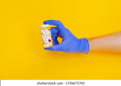 Male Doctor Hand In Gloves Holding Bottle With Capsule Pills Isolated. Online Order Prescription From Pharmacy. Safe Contact Less Medicine Delivery. Pharmaceutical Business. Copy Space Mock Up