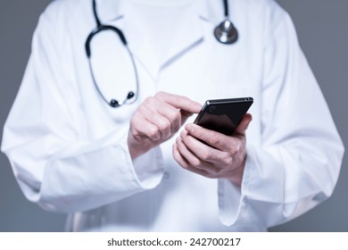 Male Doctor Hands Using Mobile Phone, Horizontal