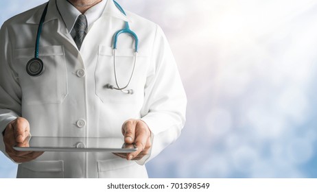 Male Doctor Holding Digital Tablet Computer On Hospital Background. Concept Of Medical Technology, Healthcare Data Diagnosis By Doctor.