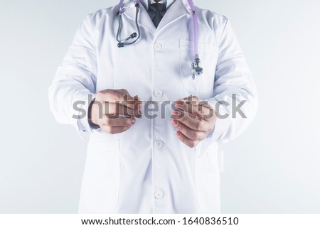 Male doctor holding in hand thermometer indicating high temperature close-up