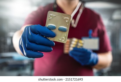 Male Doctor Holding  Pack Of Different Tablet Pills In Hospital Room. Disease Healing Concept