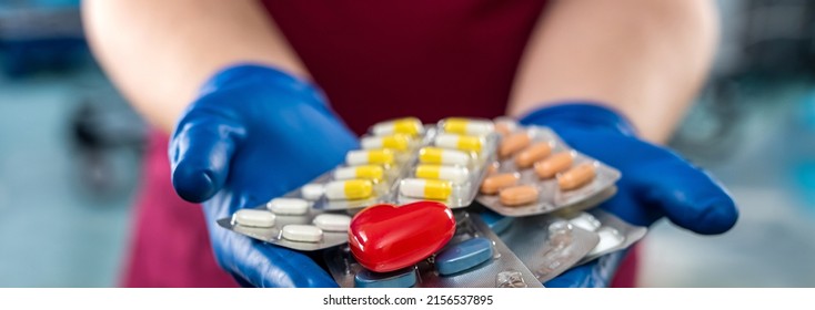 Male Doctor Holding  Pack Of Different Tablet Pills In Hospital Room. Disease Healing Concept