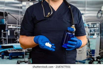 Male Doctor Holding  Pack Of Different Tablet Pills In Hospital Room. Disease Healing Concept