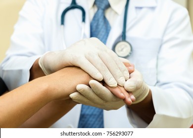 Male doctor holding patient's hand with care, concept protect care
