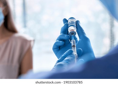 Male Doctor Holding Syringe Taking Coronavirus Vaccine Dose From Vail Preparing For Covid 19 Vaccination Side Effects For Patient. Flu Influenza Vaccine Clinical Corona Virus Treatment Inoculation