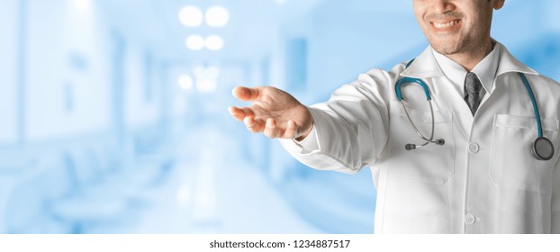 Male Doctor At Hospital Opening Hand Palm To Build Copy Space For Your Text And Design. Medical Healthcare Business And Doctor Service.