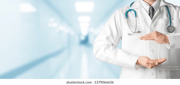 Male Doctor At Hospital Opening Hand Palm To Build Copy Space For Your Text And Design. Medical Healthcare Business And Doctor Service.