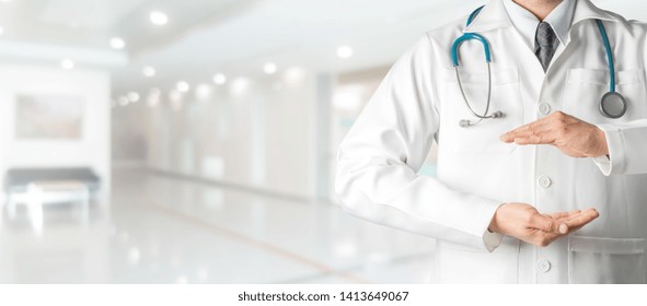 Male Doctor At Hospital Opening Hand Palm To Build Copy Space For Your Text And Design. Medical Healthcare Business And Doctor Service.