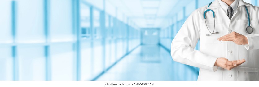 Male Doctor At Hospital Opening Hand Palm To Build Copy Space For Your Text And Design. Medical Healthcare Business And Doctor Service.