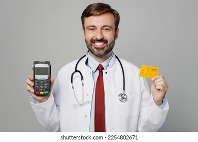 Male doctor man wears white medical gown suit stethoscope work in hospital hold bank payment terminal process acquire credit card isolated on plain grey color background Healthcare medicine concept - Shutterstock ID 2254802671