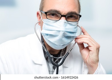 Male Doctor With Medical Facemask And Stethoscope