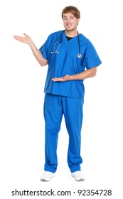 Male Doctor / Nurse Showing Presenting Copy Space Standing In Full Body Isolated On White Background. Young Medical Professional Caucasian Man.