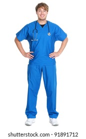 Male Doctor Or Nurse Standing Isolated In Full Body On White Background. Young Medical Professional. Caucasian Man In His Twenties Wearing Blue Scrubs And Stethoscope.