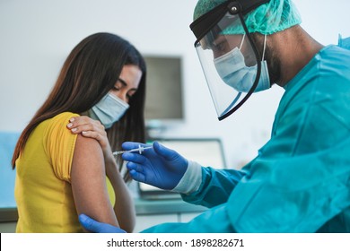 Male doctor or nurse vaccine to a patient's shoulder - Vaccination and prevention against coronavirus pandemic - Shutterstock ID 1898282671