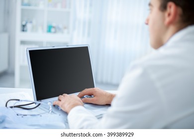 Male Doctor In The Office Using A Computer