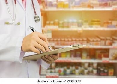 Male Doctor ,pharmacist With Stethoscope Holding Clipboard And Writing A Prescription, At The Hospital Order Medicine By Pharmacy,Healthcare And Medical Concept,selective Focus