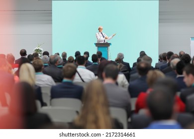 Male doctor presenting on stage at a medical conference event in front of audience - Shutterstock ID 2172314661