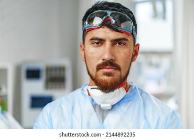 Male Doctor In Protective Medical Gown Standing In Hospital Cabinet