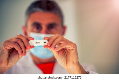 Male Doctor Showing Patient Negative Test Outcome For Covid