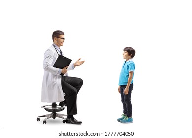 Male Doctor Sitting On A Chair And Talking To A Child Isolated On White Background