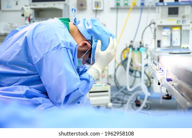 Male doctor sitting sad and feeling stressed I was disappointed with the operation in the operating room at the hospital. - Powered by Shutterstock
