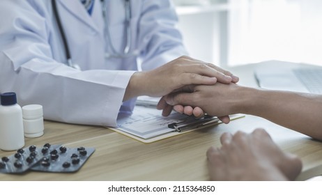 Male doctor specializing in psychiatrist comforts an anxious depression patient for medical treatment in a hospital diagnostic room, Medical treatment and health care concept. - Shutterstock ID 2115364850