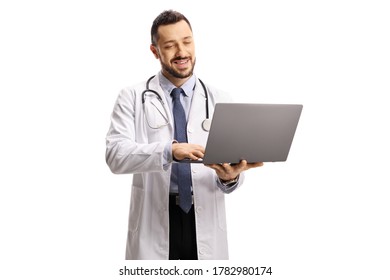 Male Doctor Standing And Working On A Laptop Isolated On White Background