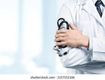 Male doctor with stethoscope on blurred hospital