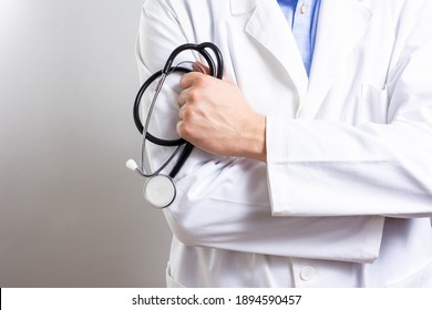 Male doctor with stethoscope on light grey background. Healthcare and medical concept. Man doctor with a black stethoscope