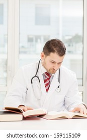 Male Doctor Is Studying With Books 