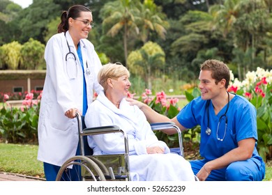 male doctor talking to senior patient in hospital garden