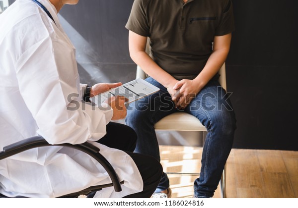 Male doctor and testicular cancer patient\
are discussing about testicular cancer test report. Testicular\
cancer and prostate cancer\
concept.
