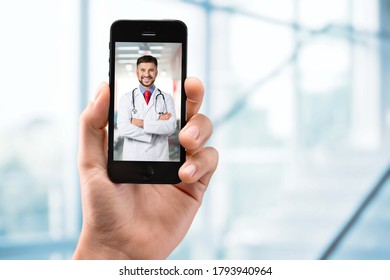 Male Doctor Or Therapist Help On Video Conference Call Remotely With Smartphone