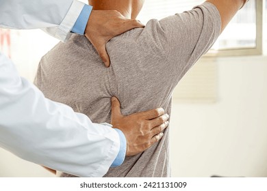 Male doctor therapist working examining treating injured back.Back pain patient, treatment, medical doctor,massage for back pain relief office syndrome. - Powered by Shutterstock