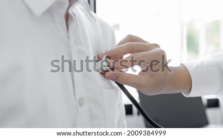 Male doctor uses a stethoscope to measure the patient's heart to check for any abnormalities in his body, Attending an annual health check in a hospital or clinic, Healthcare and medical concept.